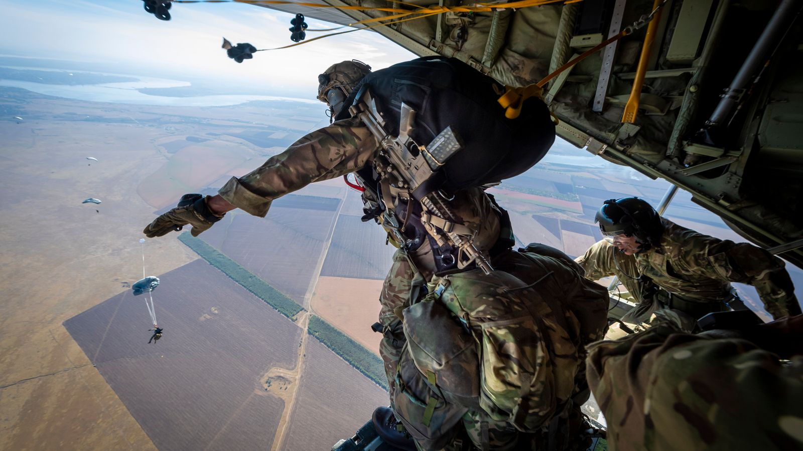 British troops perform largest parachute drop for decades 'to show solidarity' with Ukraine | UK News | Sky News
